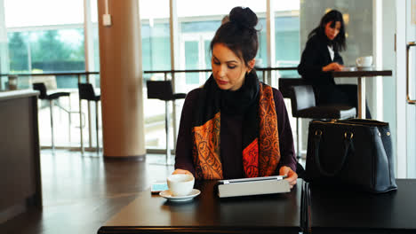 Female-executive-working-while-having-coffee