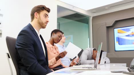 Tired-business-colleagues-sitting-in-boardroom-4k