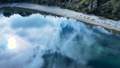 aerial tour of the crystal clear, impressive mirror image of the sky at lake moreno in patagonia, argentina