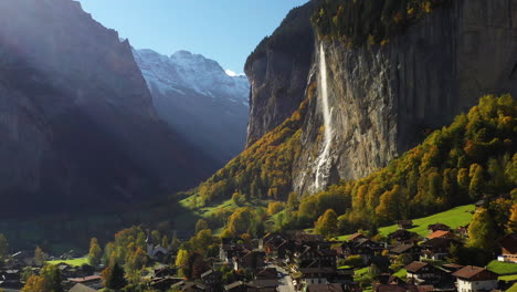 Rotierende-Drohnenaufnahme-Eines-Dorfes-Und-Des-Staubbach-wasserfalls-In-Lauterbrunnen,-Schweiz