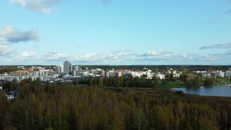 Traveling-truck-right-from-the-Järvenpää-skyline-between-a-natural-forest,-overpopulation-control-and-Finland,-quality-of-life-and-sustainability