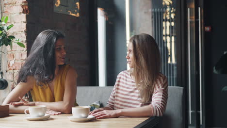 women friends enjoying coffee at a cafe