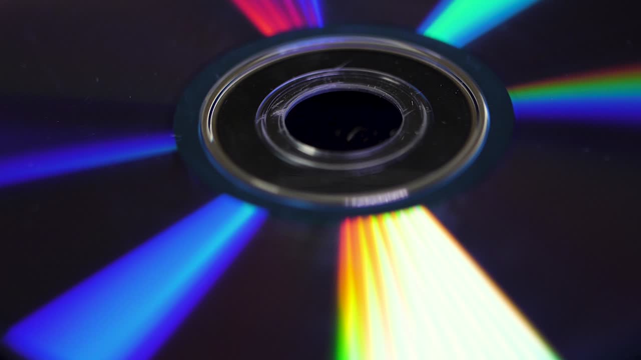 Background of compact disks or dvds. Glare of light on the disk DVD , beautiful colored glare from the light, the background disk DVD