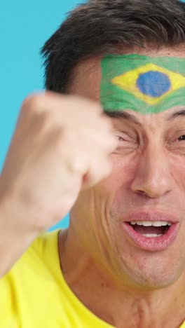 close up of a man supporting brazilian team