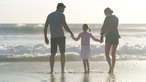 family walking together on the beach to bond