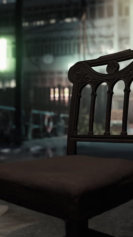 an old, wooden chair sits on a city street at night.