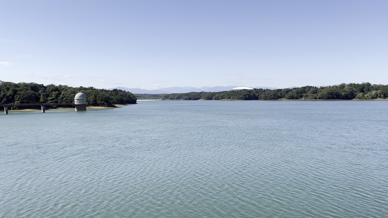 View of Tama Lake seen from Sayama Park, Tokyo on a Sunny Day. It was take on early Autumn. Structure seen at the left is a Water Utility Facility.