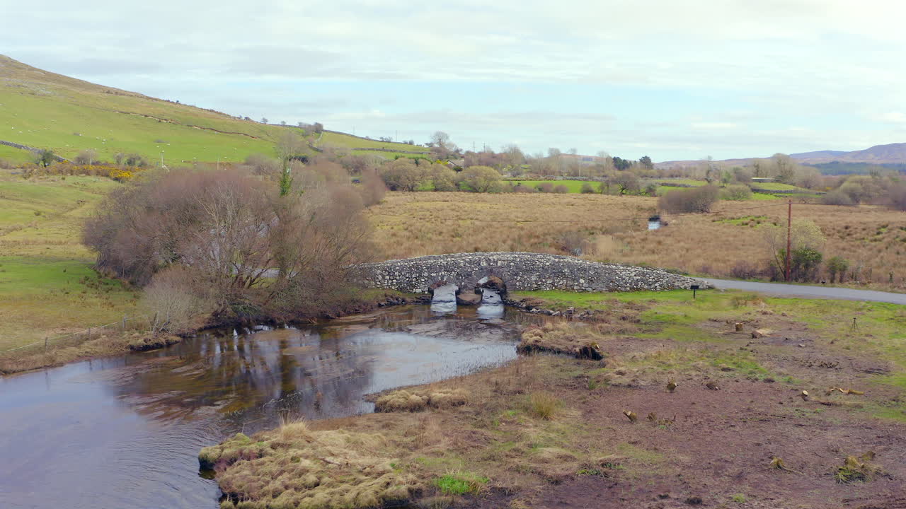 Dynamic aerial of Quiet Man Bridge in rural Connemara, Galway, Ireland
