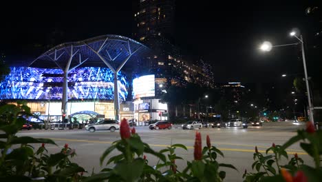 night view of modern city street with illuminated buildings and traffic