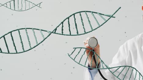 animation of dna strands moving over hand of caucasian doctor holding stethoscope on grey background