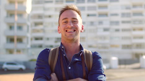 Portrait-of-smiling-tourist-carrying-backpack