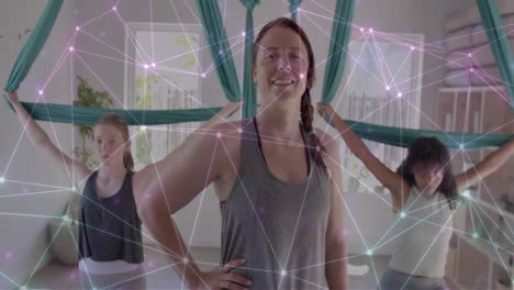 Animation-Eines-Leuchtenden-Netzwerks-über-Verschiedenen-Weiblichen-Trainerinnen-Und-Teenager-Mädchen,-Die-Aerial-Yoga-Praktizieren