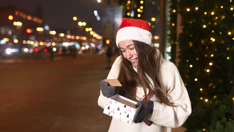 woman opening a gift on christmas night