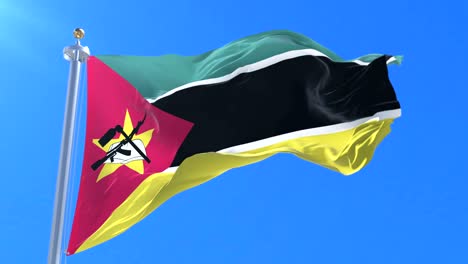 Flag of Mozambique waving at wind in slow in blue sky, loop