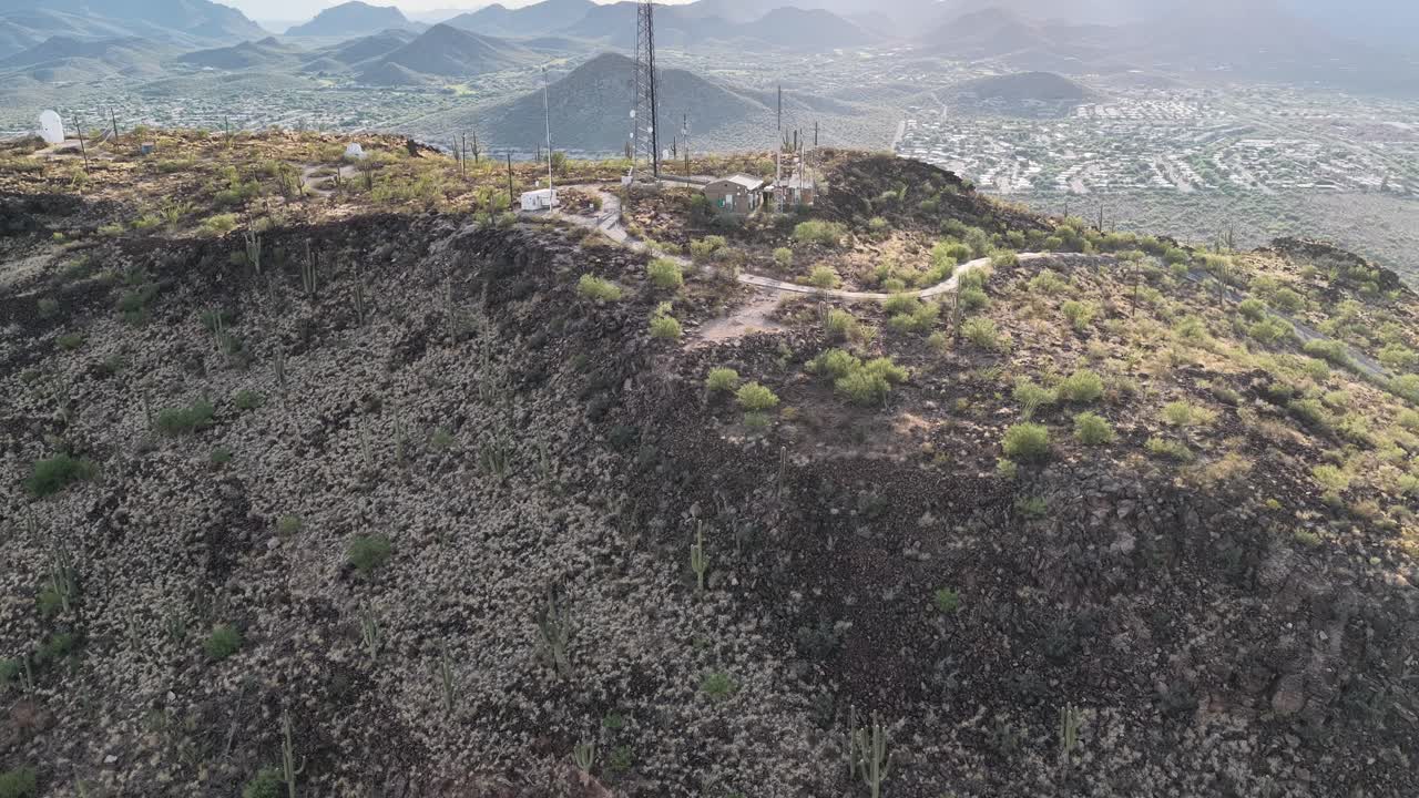 Ascending drone shot of peak of Tumamoc Hill in Tucson, Arizona