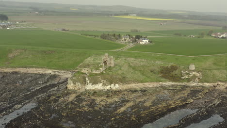 an aerial view of newark castle on the fife coastal path, scotland