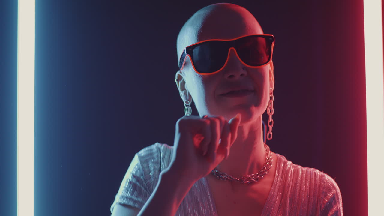 Stylish Bald Woman in Neon Light