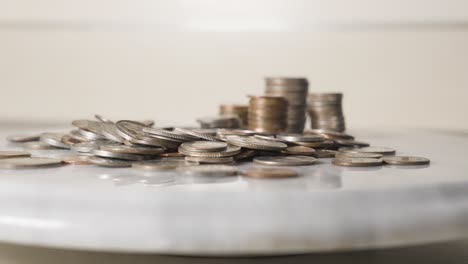 picking up coins from a pile in slow motion