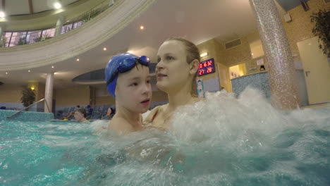 child and mom in the pool with hydromassage