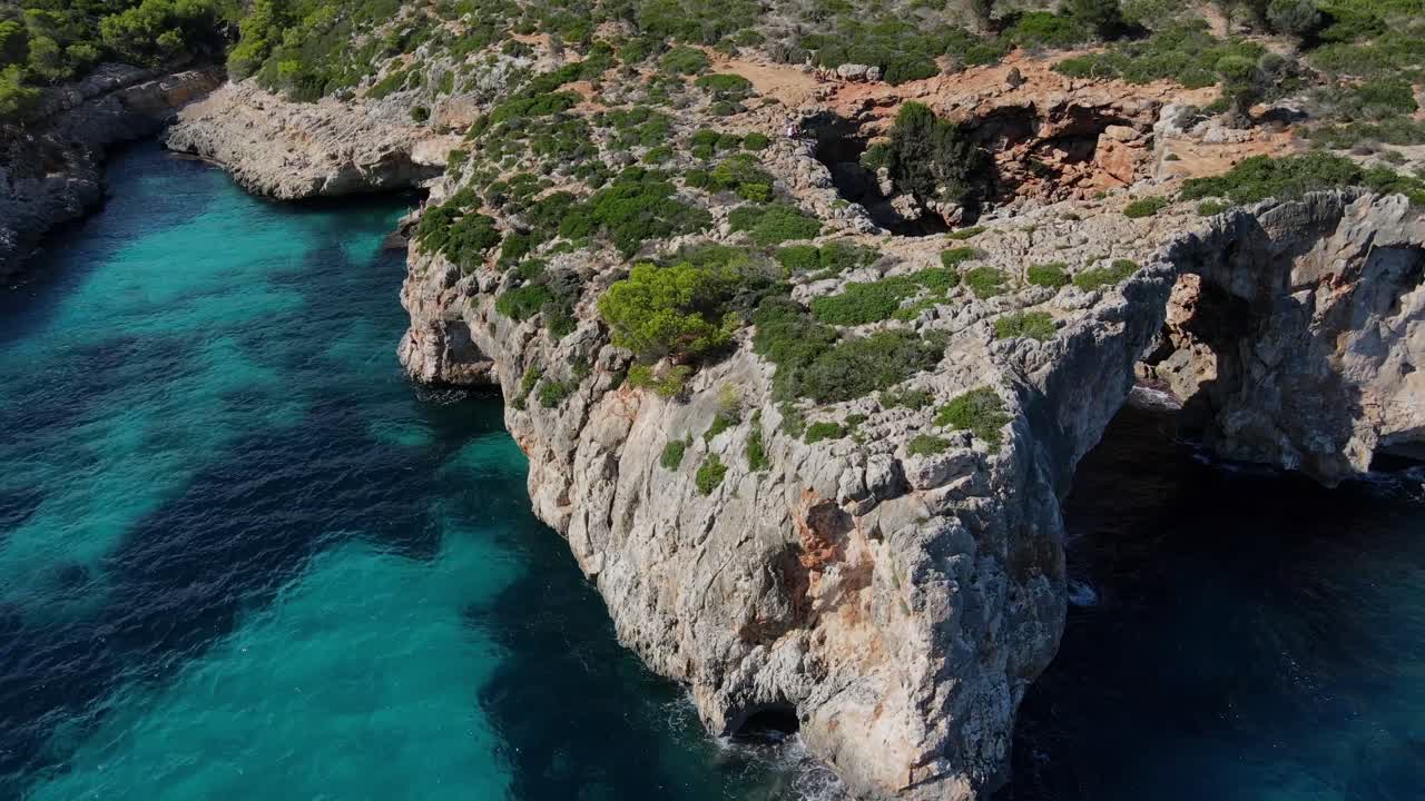 Experience the breathtaking beauty of Cala Varques, featuring crystal-clear waters and rugged cliffs in Majorca. A perfect destination for nature lovers and adventure seekers alike.