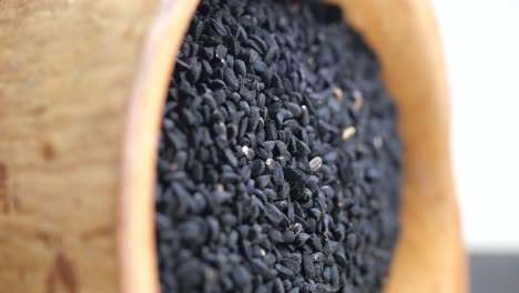 black cumin seeds (kalonji) in a wooden bowl