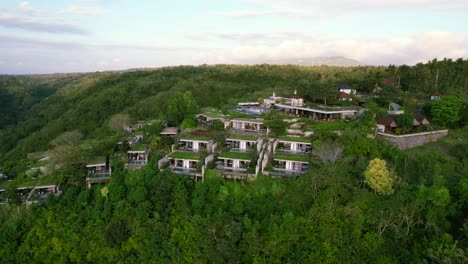 hilltop deluxe maua resort in nusa penida, bali indonesia - aerial establishing view of patchy terraced nested villas in tropical eco environment