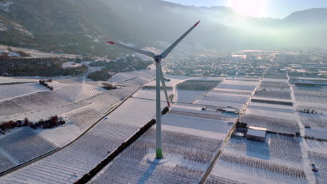 large modern windmill rotates in the rhone valley on a sunny winter day