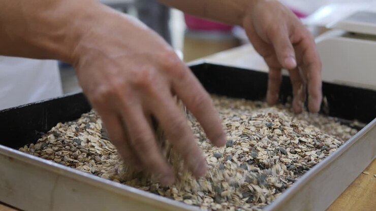 Baker Blends Dry Cereal Bar Mix By Hands In Baking Tray