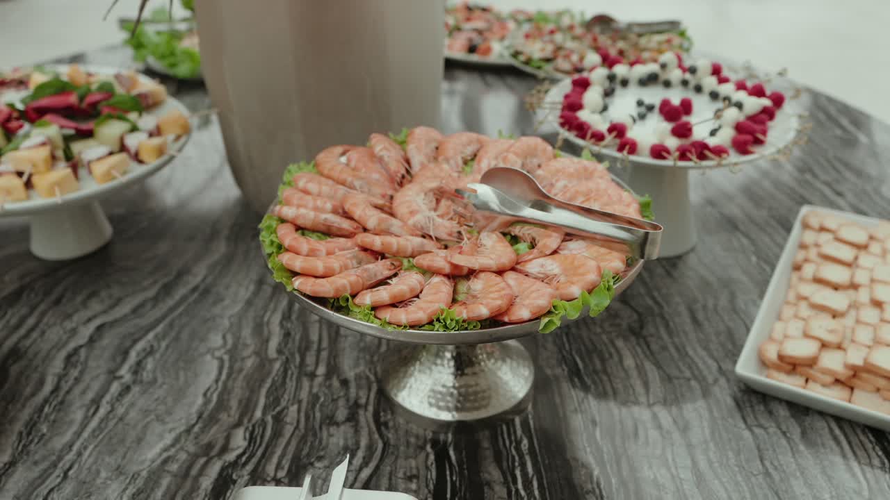 shrimp and fruit skewers served on upscale buffet table with variety