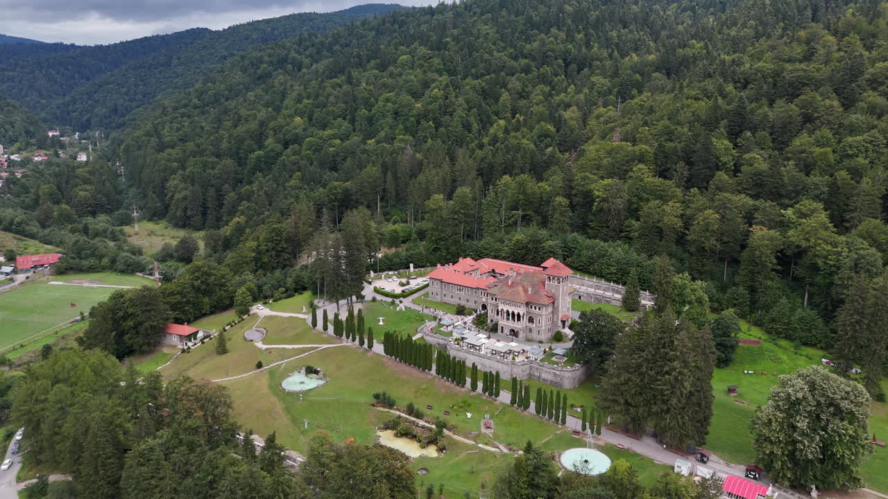 Aerial view of Cantacuzino Castle with lush green landscape in Romania