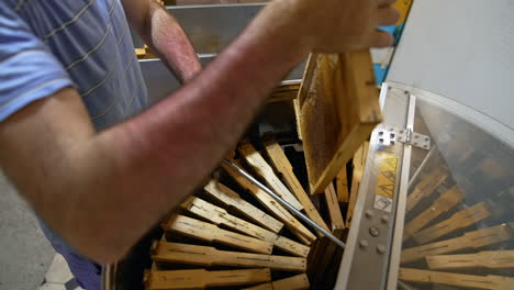 beekeeper working on a honey extractor