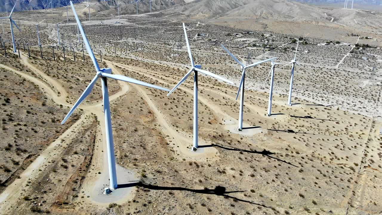 Windmills, wind turbines- aerial 4k drone push in, high angle, energy, green, renewable, huge power generating farm on desert hills, in Palm Springs, Coachella Valley, Cabazon, California