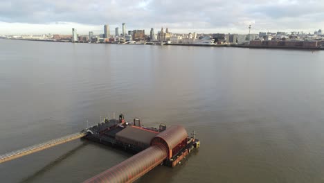 Woodside-ferry-village-terminal-aerial-left-low-orbit-across-Liverpool-harbour-skyline-pigeons-fly-through-shot