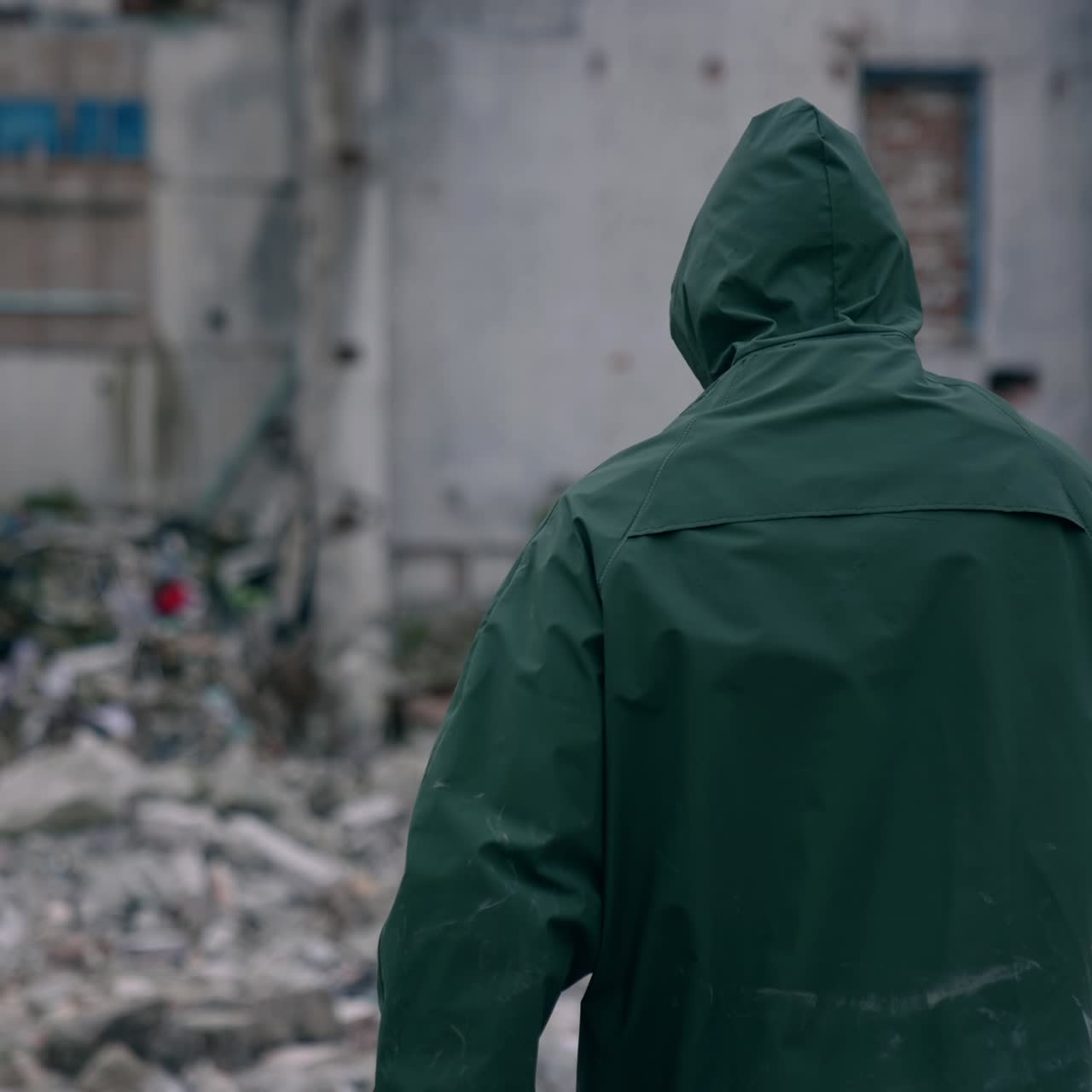 Stalker survivor after nuclear chemical war. Man in protective uniform and gas mask in destroyed place. Man-made disaster. Post apocalyptic world. Back view