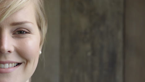 portrait-of-attractive-blonde-woman-smiling-looking-at-camera-caucasian-female-beauty-on-wooden-background-half-face