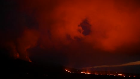 Orange-lava-flowing-in-mountainous-terrain-after-volcano-eruption-in-Spain