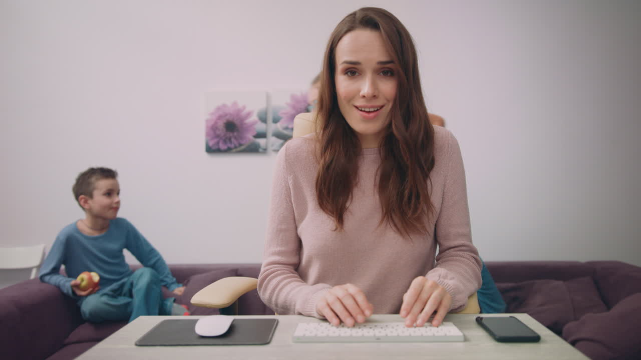 Happy business woman work at home with child on background