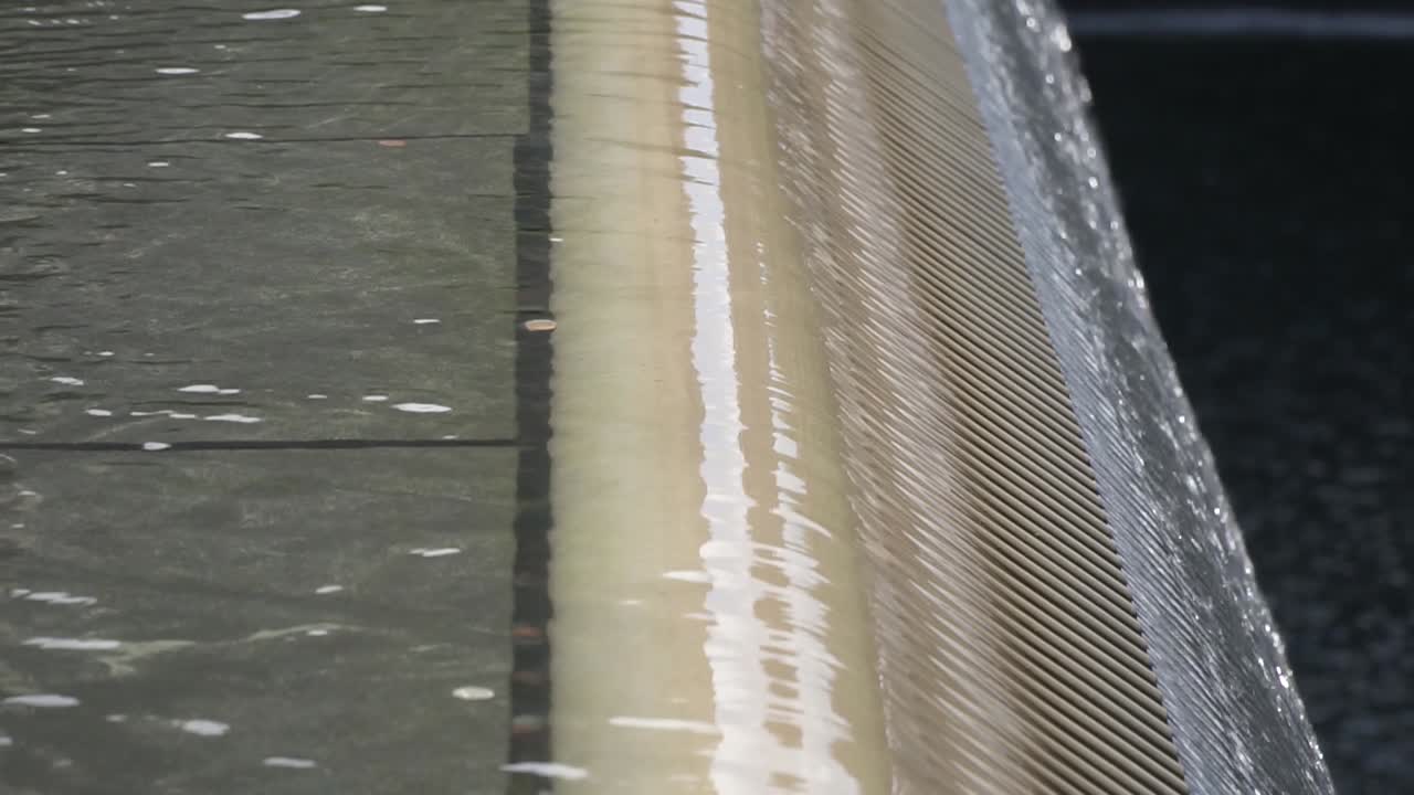 This was taken at a higher frame rate and has been converted to a slow motion video clip. World Trade Center structure, close up of the water falling.