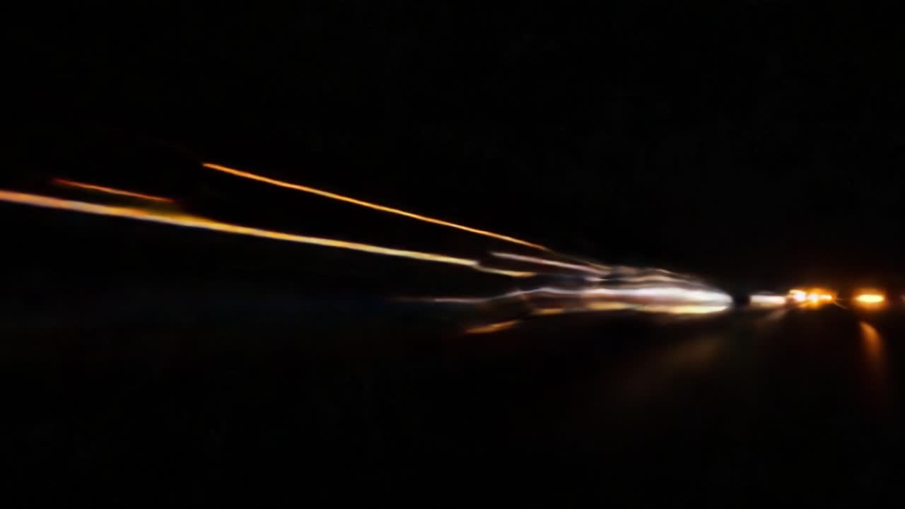 Dynamic Light Trails Captured in Motion: A Visual Exploration of Speed and Velocity on a Dark Roadway at Night