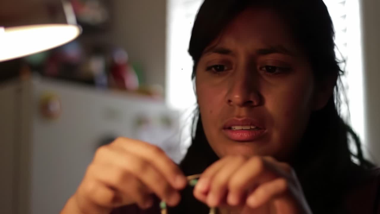 A Woman's Intense Moment of Reflection While Crafting Jewelry, Lost in Thoughts and Emotions, Portraying the Essence of Creativity and Personal Connection