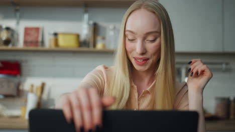 Girl finish online meeting closing laptop on kitchen closeup. Woman waving hand