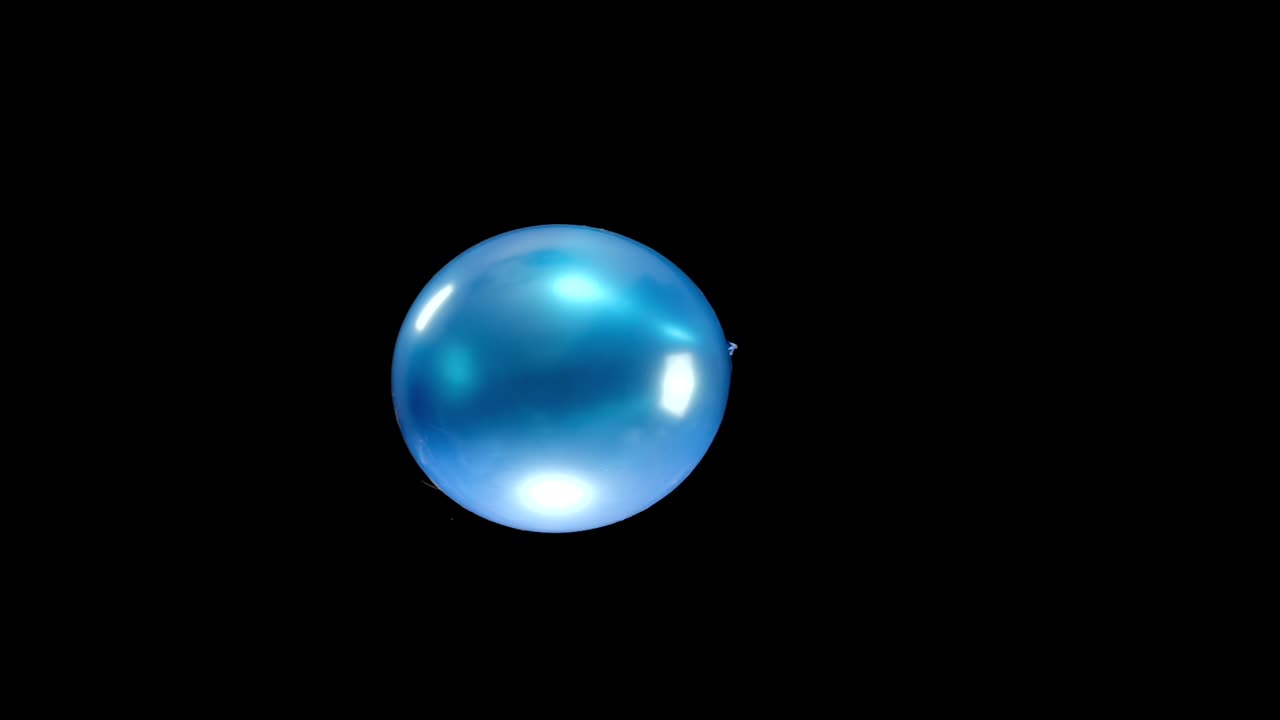 A single blue balloon gracefully falls in slow motion, with each movement captured clearly. The smooth descent against a clean background makes for a striking visual perfect for creative projects.