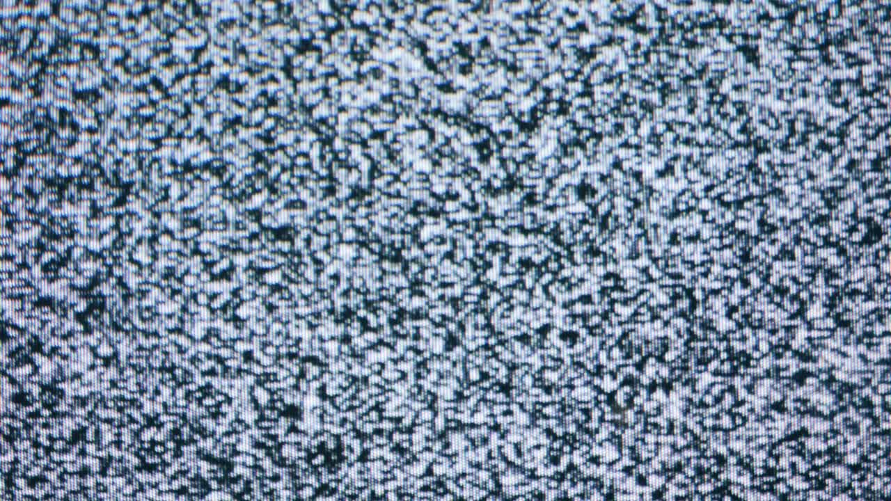 Retro TV, vintage television In a nostalgic setup, a retro TV displays grain on screen, scary halloween night device good for chroma key and green screen. High quality 4k footage