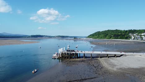 Sunny-Beaumaris-pier-aerial-view-relaxing-seaside-waterfront-tourist-attraction-Welsh-landmark-rising-forward