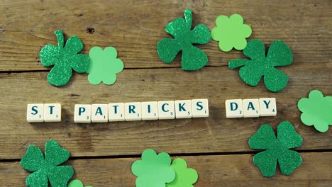 st patricks day bananagram message with shamrocks on wooden table for st patricks