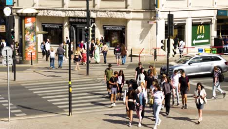 busy city street intersection with pedestrians and cars