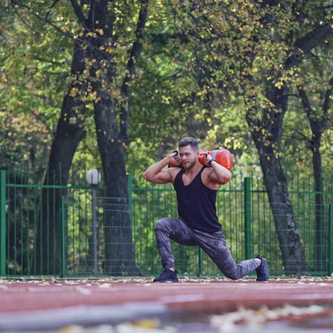 . sportsman during workout at stadium. man doing exercises during workout at stadium