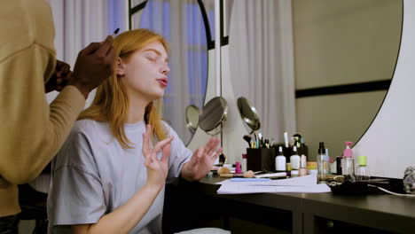 young woman checking script on dressing room