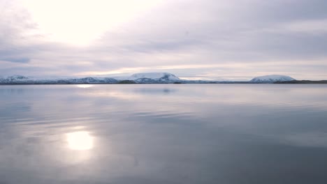 sunrise over still waters of lake myvatn and mountains around, iceland