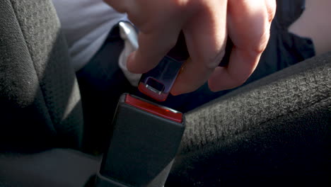 Close-up-of-a-woman-getting-into-a-car-and-buckling-her-seatbelt